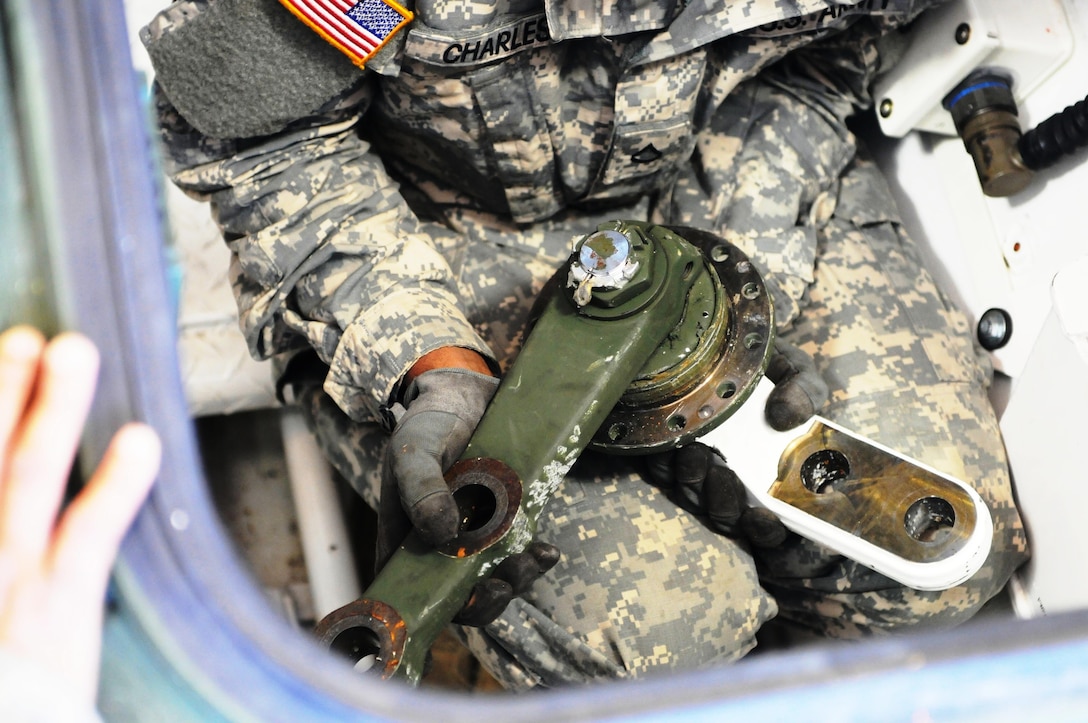 Pfc. Albert Charles, a wheeled vehicle mechanic for the 355th Chemical Company, inspects a steering component of a Nuclear, Biological, Chemical, Reconnaissance Vehicle (NBCRV) Stryker, during Field Level Maintenance New Equipment Training (FLMNET), May 7, at Joint Base Lewis-McChord, Wash. The training is being taken by both 88th RSC civilian mechanics and Soldiers of the 349th and 355th Chemical Companies, both of whom will be fielding the NBCRVs. The training is taking place April 24-May 12, at Equipment Concentration Site 10, JBLM, and is being hosted by the 88th Regional Support Command. It is the first time FLMNET has been taught in the Army Reserve.