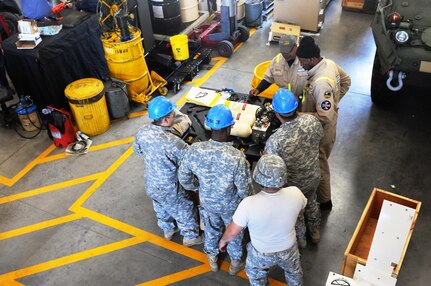 Field Level Maintenance New Equipment Training (FLMNET) instructors (top) teach Soldiers from the 355th Chemical Company, based in Las Vegas, how to disassemble nitrogen tanks from the Height Management System of a Nuclear, Biological, Chemical, Reconnaissance Vehicle (NBCRV) Stryker, during FLMNET instruction, May 8, at Joint Base Lewis-McChord, Wash. The training is being taken by both 88th RSC civilian mechanics and Soldiers of the 349th and 355th Chemical Companies, both of whom will be fielding the NBCRVs.  The training is taking place April 24-May 12, at Equipment Concentration Site 10, JBLM, and is being hosted by the 88th Regional Support Command. It is the first time FLMNET has been taught in the Army Reserve.