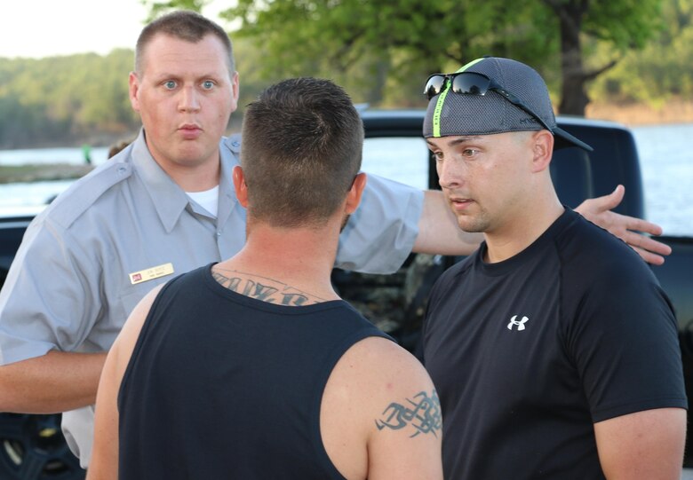 Ranger Jon Boyce attempts to diffuse a standoff between two campground visitors during a practical application exercise scenario at Washington-Irving Campground, July 15. Locals, park rangers and an Oklahoma Highway Patrolman played the role of park rangers and simulated situations park rangers often encounter.