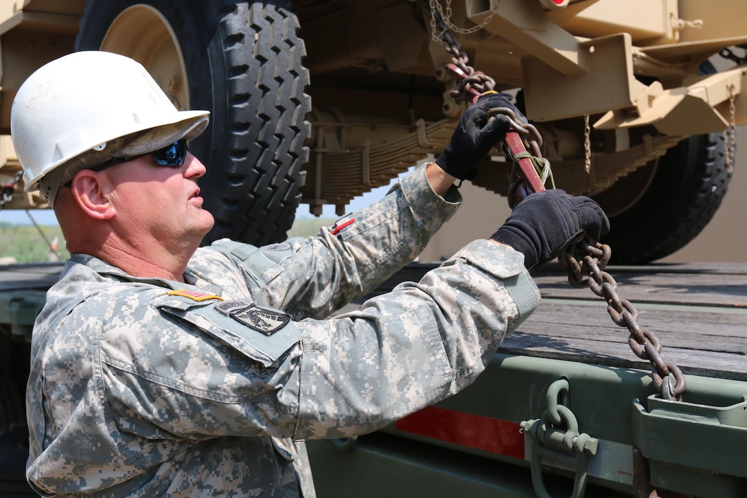 Staff Sgt. Ronald Brummand, both a civilian and military truck driver, inspects the security of his truck's cargo during the 353rd Transportation Company's convoy operation from Buffalo to Camp Roberts, Calif., July 9. The convoy operation began July 9 and will move 44 Soldiers and nearly 20 cargo-laden military vehicles more than 2,000 miles cross-country as part of an annual training initiative known as Nationwide Move. The 353rd Transportation Company's westward trek will not only provide training for its Soldiers, but also practical logistics support to its sister unit, the 322nd Maintenance Company, which will be conducting its annual training in California. (US Army Photo by Sgt Victor Ayala, 210th MPAD)