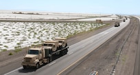 Elements of the 353rd Transportation Company, 103rd ESC passes by the Bonneville Salt Flats on its way into Nevada during the company's convoy operation from Buffalo, Minn.,  to Camp Roberts, Calif. The convoy operation began July 9 and moved 44 Soldiers and more than 20 cargo-laden military vehicles more than 2,000 miles cross-country as part of an annual training initiative known as Nationwide Move. The 353rd Transportation Company's westward trek not only provided training for its Soldiers, but also practical logistics support to its sister unit, the 322nd Maintenance Company, which will be conducting its annual training in California. (US Army  Photo by Sgt Victor Ayala, 210th MPAD)