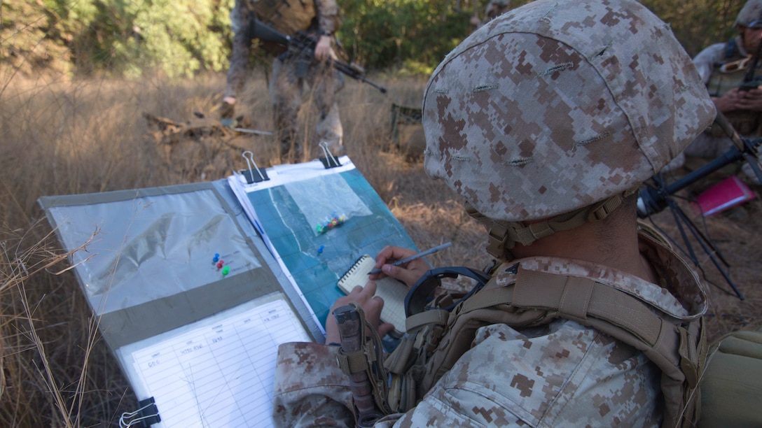U.S. Marine Lance Cpl. Brian Morales updates a map with the status and locations of different units following an amphibious assault at Fog Bay, Australia, July 11, 2015. The Marines with Echo Company, Battalion Landing Team 2nd Battalion, 5th Marines, 31st Marine Expeditionary Unit, and Australians with Combat Team Bravo, 2nd Battalion, Royal Australian Regiment, assaulted the beach and moved inland to secure additional objectives as part of Talisman Sabre 2015. Talisman Sabre is a biennial exercise designed to improve the interoperability between Australian and U.S. forces. The 31st MEU is taking part in the exercise while deployed on its regularly scheduled Fall Patrol of the Asia-Pacific region. Morales, a San Antonio native, is an intelligence clerk with Echo Co., BLT 2/5, 31st MEU. (U.S. Marine Corps photo by Staff Sgt. Zachary Dyer/Released)