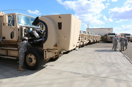 Reservists of the 353rd Transportation Company rest and perform preventive maintenance checks and services during a stop on the 353rd's convoy operation from Buffalo, Minn., to Camp Roberts, Calif. The convoy operation began July 9 and is moving 44 Soldiers and more than 20 cargo-laden military vehicles more than 2,000 miles cross country as part of an annual training initiative known as Nationwide Move. The 353rd Transportation Company's westward trek is not only providing training for its Soldiers, but also practical logistics support to its sister unit, the 322nd Maintenance Company, which will be conducting its annual training in California. (U.S. Army photo by Sgt. Victor Ayala, 210th MPAD)