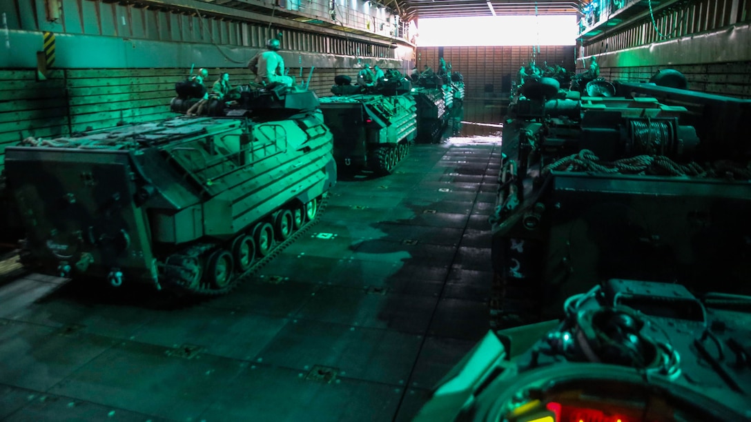 U.S. Marines and Australian service members prepare for an amphibious assault in Marine AAV-P7/A1 Amphibious Assault Vehicles in the well deck of the USS Ashland (LSD 48) July 11, 2015. The Marines with Echo Company, Battalion Landing Team 2nd Battalion, 5th Marines, 31st Marine Expeditionary Unit, and Australians with Combat Team Bravo, 2nd Battalion, Royal Australian Regiment, assaulted the beach and moved inland to secure additional objectives as part of Talisman Sabre 2015.  Talisman Sabre is a biennial exercise designed to improve the interoperability between Australian and U.S. forces. The 31st MEU is taking part in the exercise while deployed on its regularly scheduled Fall Patrol of the Asia-Pacific region. (U.S. Marine Corps photo by Cpl. Ryan C. Mains/Released)