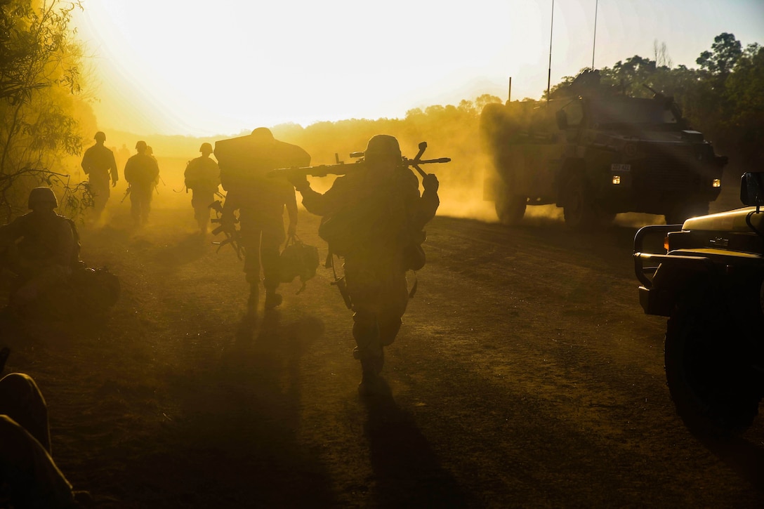 U.S. Marines and Australian service members move into defensive positions for the night after conducting an amphibious assault at Fog Bay, Australia, July 11, 2015. The Marines with Echo Company, Battalion Landing Team 2nd Battalion, 5th Marines, 31st Marine Expeditionary Unit, and Australians with Combat Team Bravo, 2nd Battalion, Royal Australian Regiment, assaulted the beach and moved inland to secure additional objectives as part of Talisman Sabre 2015.  Talisman Sabre is a biennial exercise designed to improve the interoperability between Australian and U.S. forces. The 31st MEU is taking part in the exercise while deployed on its regularly scheduled Fall Patrol of the Asia-Pacific region. (U.S. Marine Corps photo by Cpl. Ryan C. Mains/Released)