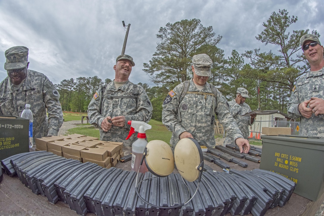 U.S. Army Reserve Soldiers with 3rd Bn., 321st Regt., 108th Training Command have a good time loading 5.56 mm rounds into M16 magazines for fellow 108th Soldiers to zero their weapons on firing range number four at Fort Jackson, S.C., April 11, 2015. (U.S. Army photo by Sgt. Ken Scar)