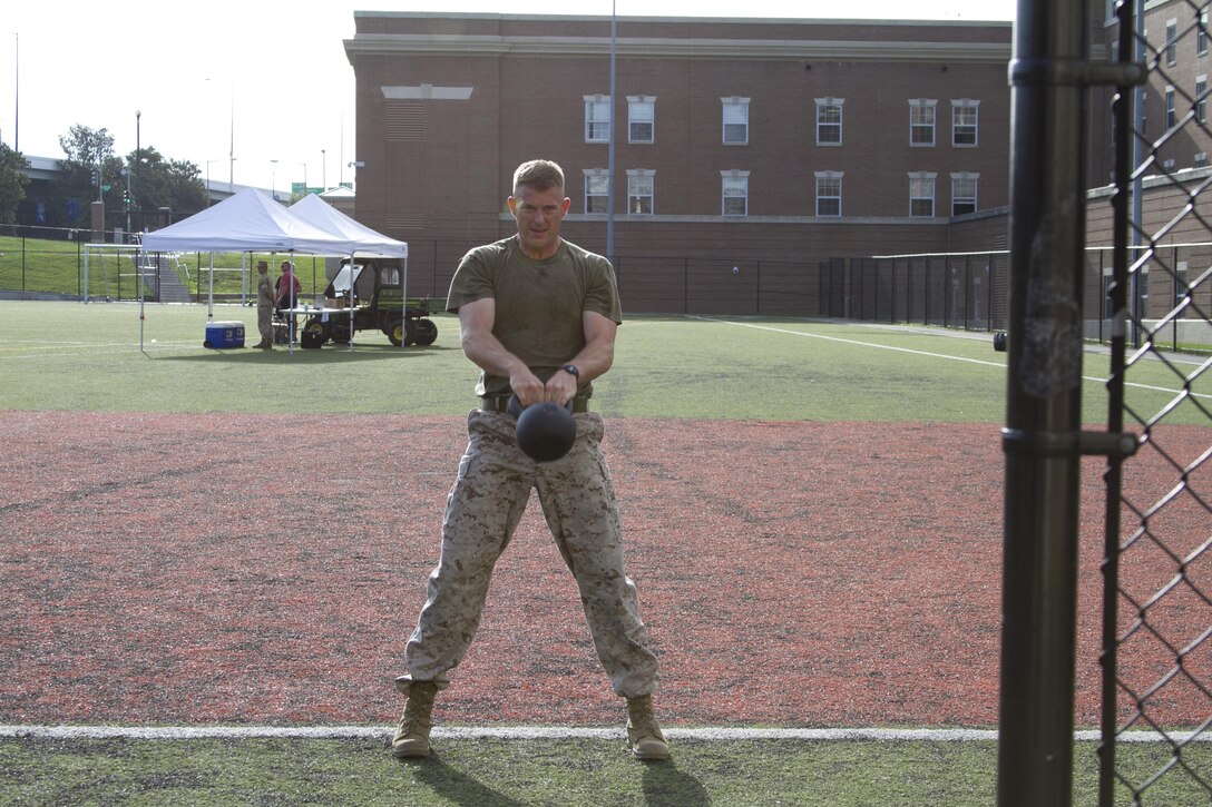 Capt. Mark Batey, Bravo Company executive office, competes in the kettle-bell and burpee challenge during the High Intensity Tactical Training athlete competition at Marine Barracks Washington, D.C., July 15, 2015. Marine Corps Community Services hosted the first High Intensity Tactical Training athlete competition. The United States Marine Corps HITT program is to improve operation fitness levels and overall combat readiness while reducing the likelihood of injury and ensuring that all Marines are physically prepared for combat. 