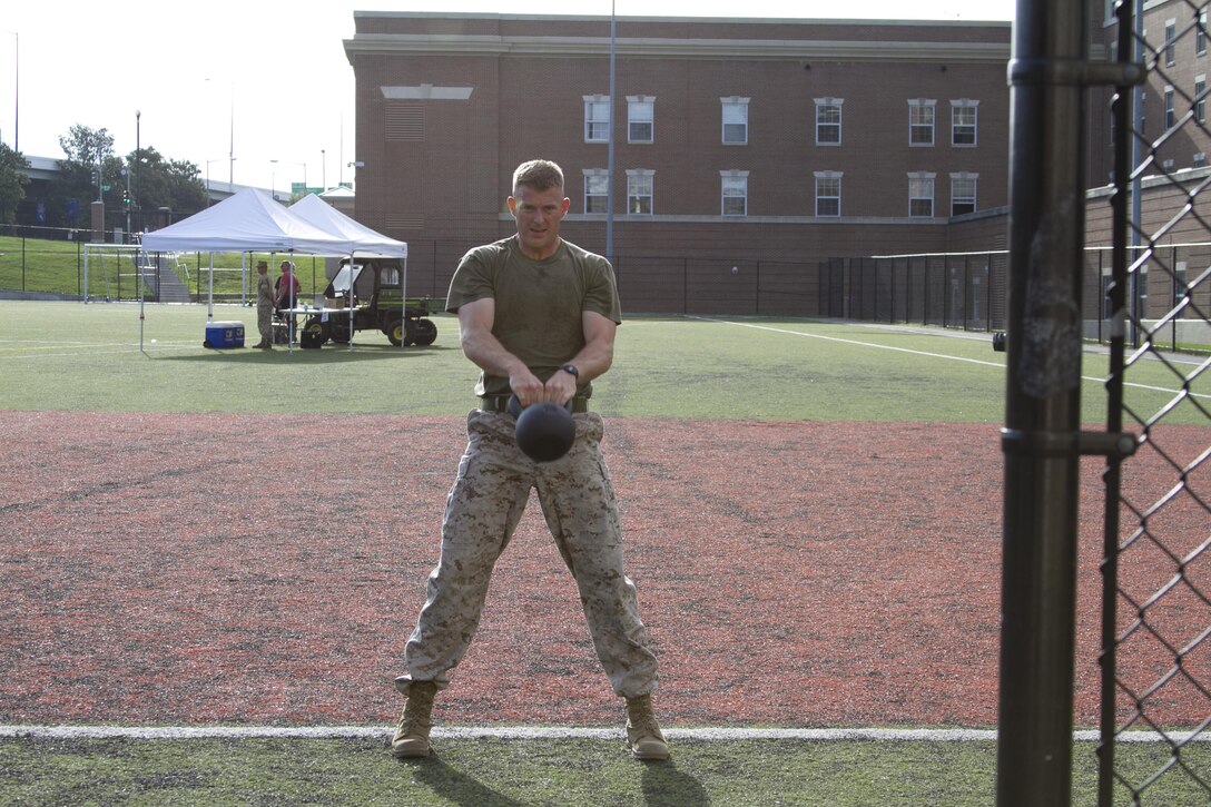 Capt. Mark Batey, Bravo Company executive office, competes in the kettle-bell and burpee challenge during the High Intensity Tactical Training athlete competition at Marine Barracks Washington, D.C., July 15, 2015. Marine Corps Community Services hosted the first High Intensity Tactical Training athlete competition. The United States Marine Corps HITT program is to improve operation fitness levels and overall combat readiness while reducing the likelihood of injury and ensuring that all Marines are physically prepared for combat. 