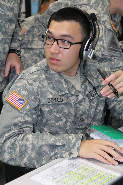 Pfc. Bronson M. Donald, internment resettlement specialist, 303rd Maneuver Enhancement Brigade, 9th Mission Support Command, operates the Command Post of the Future (CPOF) system along with Ventrilo for his military police section during the Imua Dawn exercise, here, July 5. CPOF allows commanders to maintain sight over the battlefield, while Ventrilo provides synchronous voice collaboration via Voice over Internet Protocol (VoIP).