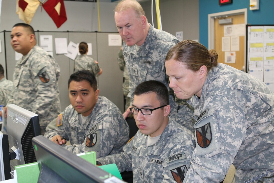 Pfc. Bronson M. Donald and his team of military police officers review and strategize the battlefield through the Command Post of the Future (CPOF) system during the Imua Dawn exercise, here, which kicked off June 28. CPOF allows commanders to maintain sight over the battlefield and enable collaboration with superiors, peers and subordinates over live data.