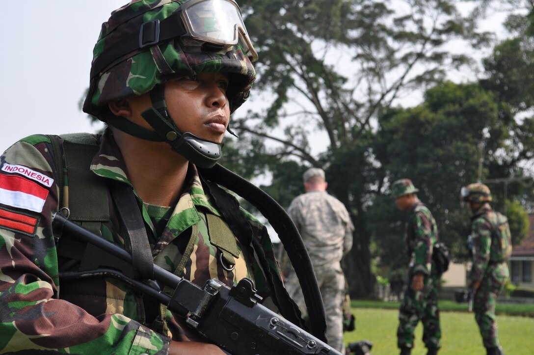 An Indonesian Armed Forces private provides security for his fellow soldiers while they identify a potential threat as part of counter improvised explosive device training, the focus of the field training exercise during Exercise Garuda Shield, June 14. Over the course of two weeks, U.S. Soldiers from the Asia Pacific C-IED Fusion Center are training approximately 240 Indonesian soldiers on identifying and defeating IEDs and how to react when facing danger.