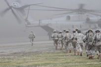 Soldiers of the U.S. Army Reserve Theater Support Group - Pacific race to a CH-53 Marine helicopter for a simulated medical evacuation during their first consolidated annual training event at Bellows Air Force Base, March 6.