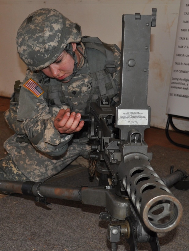 Spc. Jessica Storch, a medic with the 1984th U.S. Army Hospital, disassembles an M2-50 caliber machine gun during the weapons demonstration portion of this year‚Äôs 9th Mission Support Command Best Warrior competition, here, April 23. (Photo by Spc. Phil Regina, 305th Mobile Public Affairs Detachment)
