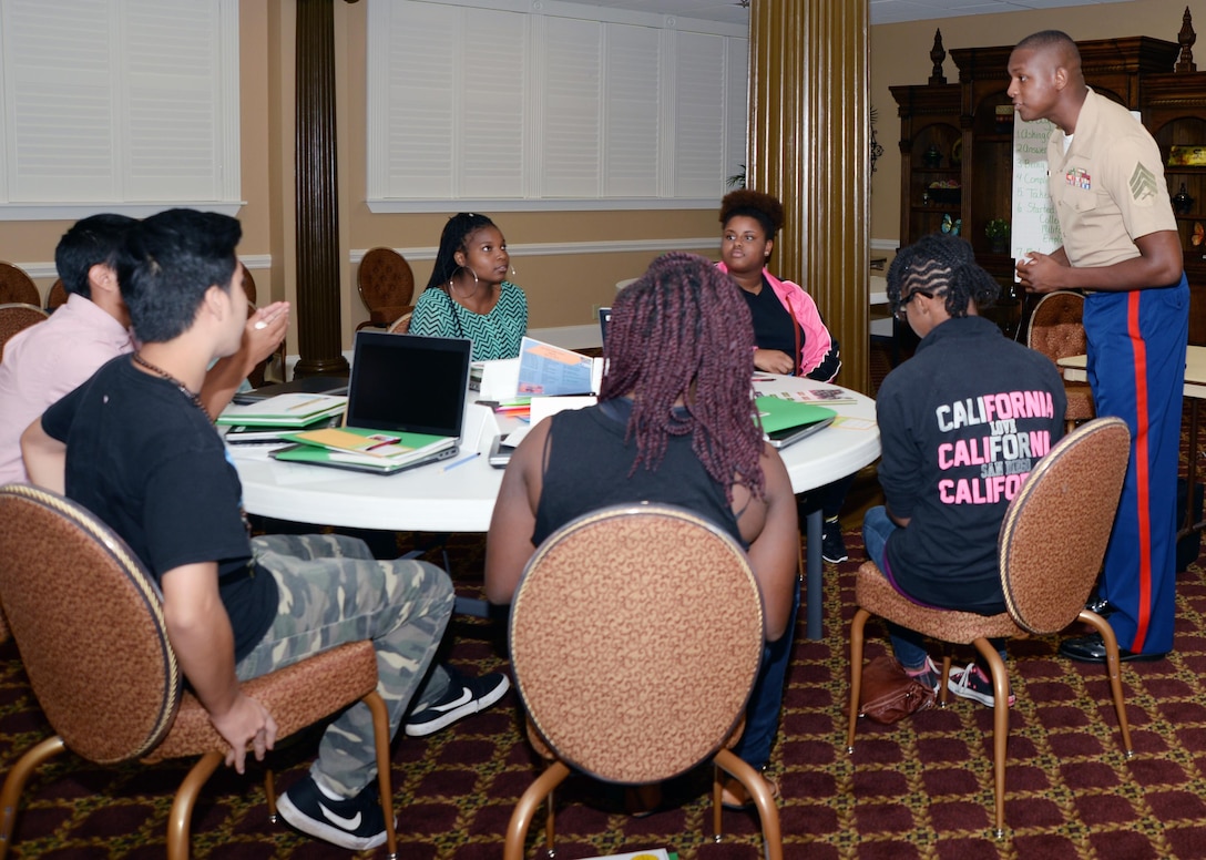 Sgt. Marcus Keyes, recruiter, Recruiting Station Jacksonville, Fla., listens to a question from a student during the “Life After High School” seminar at the Town and Country Restaurant’s Grand Ballroom aboard Marine Corps Logistics Base Albany, July 14. 