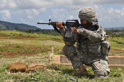 Spc. Dana Tamayo fires rounds from the crouching position during the M16 qualification portion of this year‚Äôs 9th Mission Supp Support Command‚Äôs Best Warrior Competition, here, April 22. (Photo by Spc. Phil Regina)