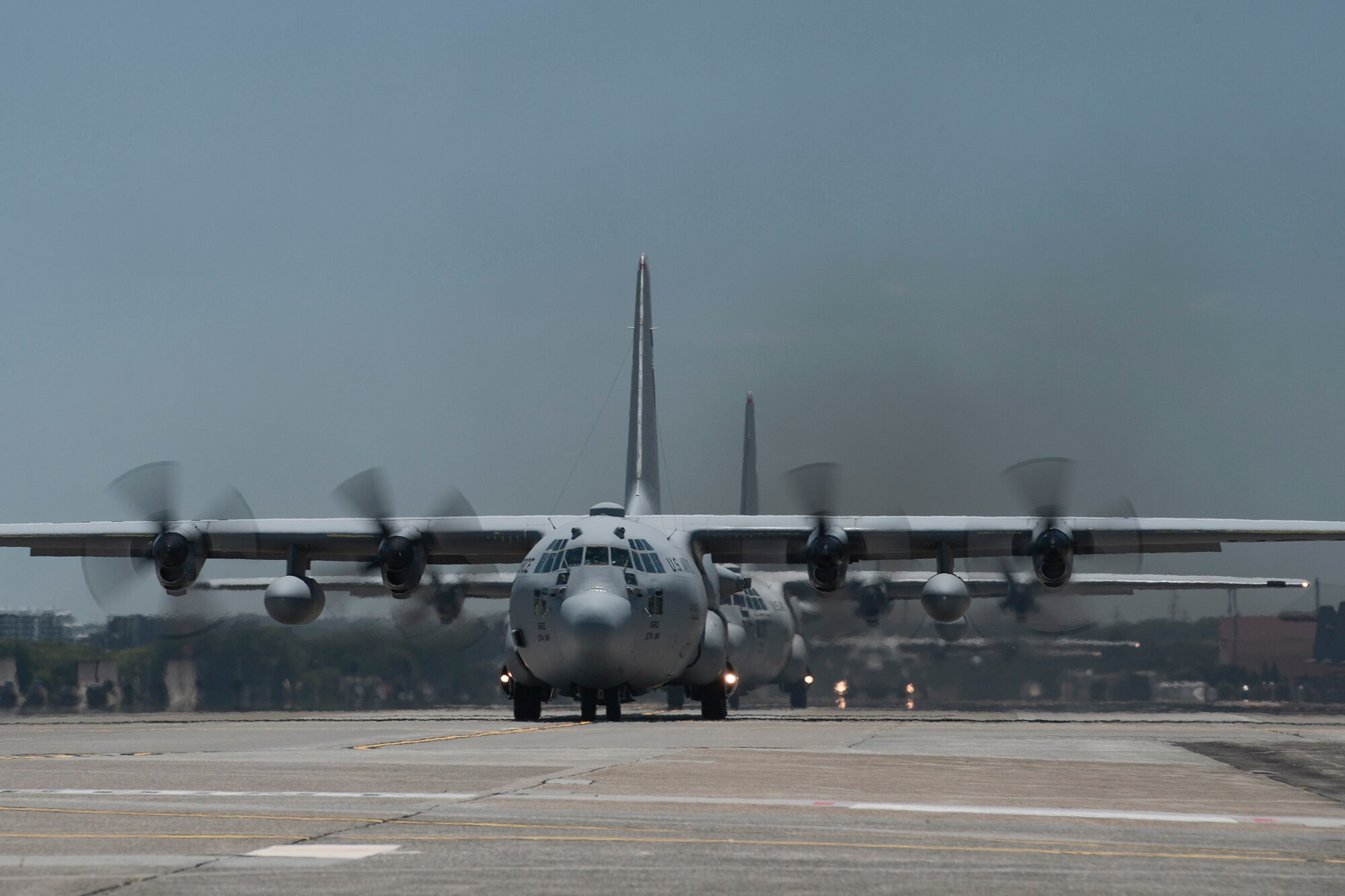 Multiple U.S. Air Force C-130 Hercules taxi during large formation training, Yokota Air Base, Japan, July 14, 2015. Nine C-130s took off during the training, practicing their large formation and airlift capabilities. (U.S. Air Force photo by Staff Sgt. Cody H. Ramirez/ Released) 
