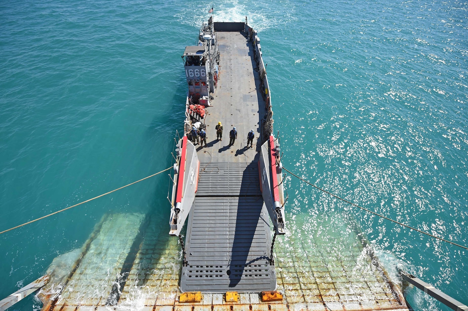 INDIAN OCEAN (July 12th, 2015) - Sailors onboard Landing Craft Utility (LCU) 1666, assigned to Naval Beach Unit (NBU) 7, wait to take on equipment from the amphibious dock landing ship USS Ashland (LSD 48) during a beach exercise for Talisman Sabre 2015. Talisman Sabre is a bilateral exercise intended to train Australian and U.S. forces in planning and conducting combined task force operations. 