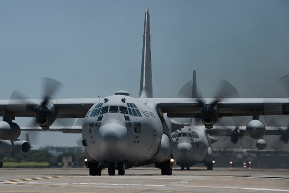 Multiple U.S. Air Force C-130 Hercules with the 374th Airlift Wing taxi during large formation training, Yokota Air Base, Japan, July 14, 2015. The training allowed aircrews an opportunity to practice their large formation and airlift capabilities. (U.S. Air Force photo by Staff Sgt. Cody H. Ramirez/Released) 