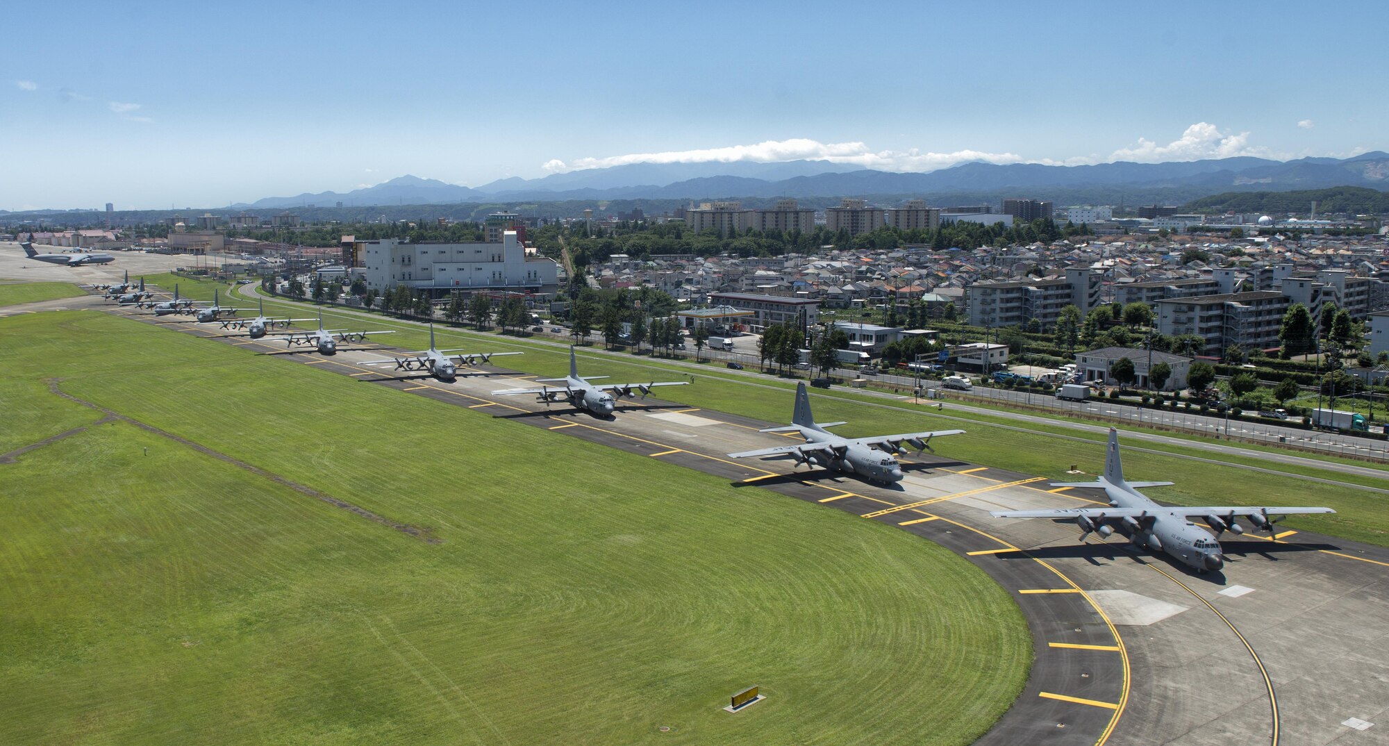 Ten U.S. Air Force C-130 Hercules aircraft taxi down a runway during a training exercise, July 14, 2015, Yokota Air Base, Japan. The exercise tested Yokota's ability to perform large-force employment and tactics. (U.S. Air Force photo by Airman 1st Class Delano Scott/Released)