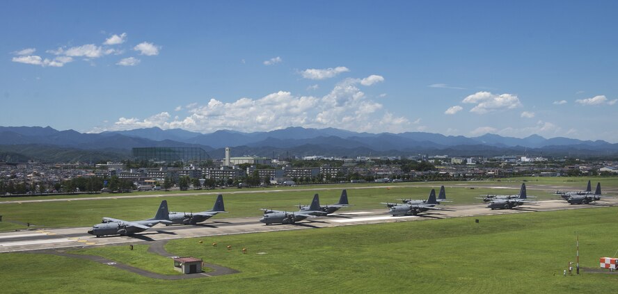 Ten U.S. Air Force C-130 Hercules aircraft taxi down a runway during a training exercise, July 14, 2015, Yokota Air Base, Japan. The 36th Airlift Squadron regularly tests its mission capabilities to ensure readiness. (U.S. Air Force photo by Airman 1st Class Delano Scott/Released)
