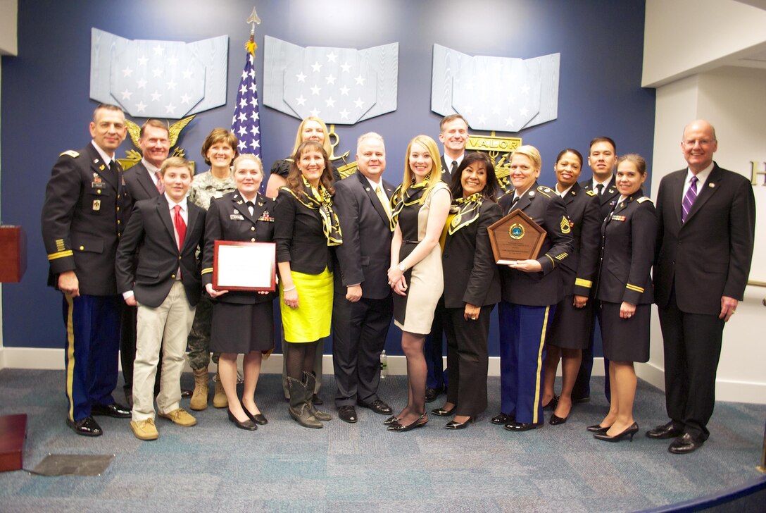 Reserve Family Readiness Award winners from the 134th Legal Operations Detachment pose alongside officials from United States Army Reserve, the Office of the Secretary of Defense for Reserve Affairs and the Military Officers Association at a Feb. 28, 2014, award ceremony in the Pentagon's Hall of Heroes. Left to right, Col. Ronald Dean Rallis Sr., commander, 134th Legal Operations Detachment; John T. Hastings, deputy assistant secretary of defense for reserve affairs, resources; Nicholas Kroll, son of Lt. Col. Lori Kroll; Brig. Gen. LeAnne P. Burch, commanding general, United States Army Reserve Legal Command; Lt. Col. Lori Kroll, 134th Legal Operations Detachment team leader and Unit Family Readiness Group liaison; Sherry Rallis, 134th Family Readiness Group leader; (behind Mrs. Rallis) Andrea Treptow, 134th Family Readiness Group newsletter chairperson; Hans Dekker, 134th Family Readiness Group treasurer; Jennifer Mercado, 134th Family Readiness Group volunteer; Lt. Col. Owen Lewis, 134th deputy commander; Sandra Bramble, master trainer, Army Community Services, 134th Family Readiness Group; Sgt. 1st Class Carla Corona, 134th family assistant; Maj. Gen. Marcia M. Anderson, deputy chief, Army Reserve; Capt. Rufus Allen, 134th member; Capt. Shelley O'Hara, 134th member; retired U.S. Navy Vice Adm. Norb Ryan, president of the Military Officers Association of America. (Photo by Lt. Col. Roburt C. Yale, unit public affairs representative, USAR Legal Command)