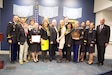 Reserve Family Readiness Award winners from the 134th Legal Operations Detachment pose alongside officials from United States Army Reserve, the Office of the Secretary of Defense for Reserve Affairs and the Military Officers Association at a Feb. 28, 2014, award ceremony in the Pentagon's Hall of Heroes. Left to right, Col. Ronald Dean Rallis Sr., commander, 134th Legal Operations Detachment; John T. Hastings, deputy assistant secretary of defense for reserve affairs, resources; Nicholas Kroll, son of Lt. Col. Lori Kroll; Brig. Gen. LeAnne P. Burch, commanding general, United States Army Reserve Legal Command; Lt. Col. Lori Kroll, 134th Legal Operations Detachment team leader and Unit Family Readiness Group liaison; Sherry Rallis, 134th Family Readiness Group leader; (behind Mrs. Rallis) Andrea Treptow, 134th Family Readiness Group newsletter chairperson; Hans Dekker, 134th Family Readiness Group treasurer; Jennifer Mercado, 134th Family Readiness Group volunteer; Lt. Col. Owen Lewis, 134th deputy commander; Sandra Bramble, master trainer, Army Community Services, 134th Family Readiness Group; Sgt. 1st Class Carla Corona, 134th family assistant; Maj. Gen. Marcia M. Anderson, deputy chief, Army Reserve; Capt. Rufus Allen, 134th member; Capt. Shelley O'Hara, 134th member; retired U.S. Navy Vice Adm. Norb Ryan, president of the Military Officers Association of America. (Photo by Lt. Col. Roburt C. Yale, unit public affairs representative, USAR Legal Command)