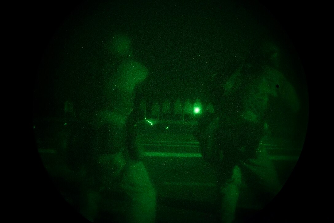 GULF OF ADEN (July 14, 2015) U.S. Marines with the 15th Marine Expeditionary Unit’s Maritime Raid Force aim at their targets during a night deck shoot aboard the amphibious assault ship USS Essex (LHD 2). Shooting accurately with low light is a critical skill for the MRF Marines so they are proficient in night-time conditions. The 15th MEU is embarked on the Essex Amphibious Ready Group and is deployed to maintain regional security in the U.S. 5th Fleet area of operations. (U.S. Marine Corps photo by Cpl. Anna Albrecht/Released)