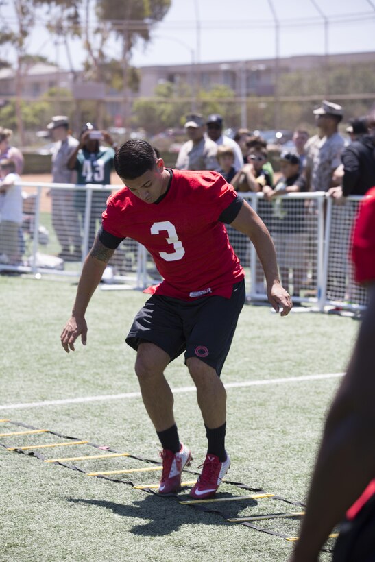Juan Reyes, a wide receiver with the Marine Corps Air Station Miramar Falcons, participates in drills during the NFL Football Star Experience at the Miramar Sports Complex, July 14. NFL players who train with Todd Durkin, owner and founder of Fitness Quest 10, came to Miramar to practice with the Miramar Falcons football team and interact with service members and families. (U.S. Marine Corps photo by Cpl. Alissa P. Schuning/Released)