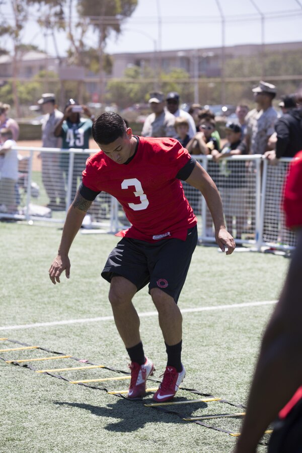 Juan Reyes, a wide receiver with the Marine Corps Air Station Miramar Falcons, participates in drills during the NFL Football Star Experience at the Miramar Sports Complex, July 14. NFL players who train with Todd Durkin, owner and founder of Fitness Quest 10, came to Miramar to practice with the Miramar Falcons football team and interact with service members and families. (U.S. Marine Corps photo by Cpl. Alissa P. Schuning/Released)