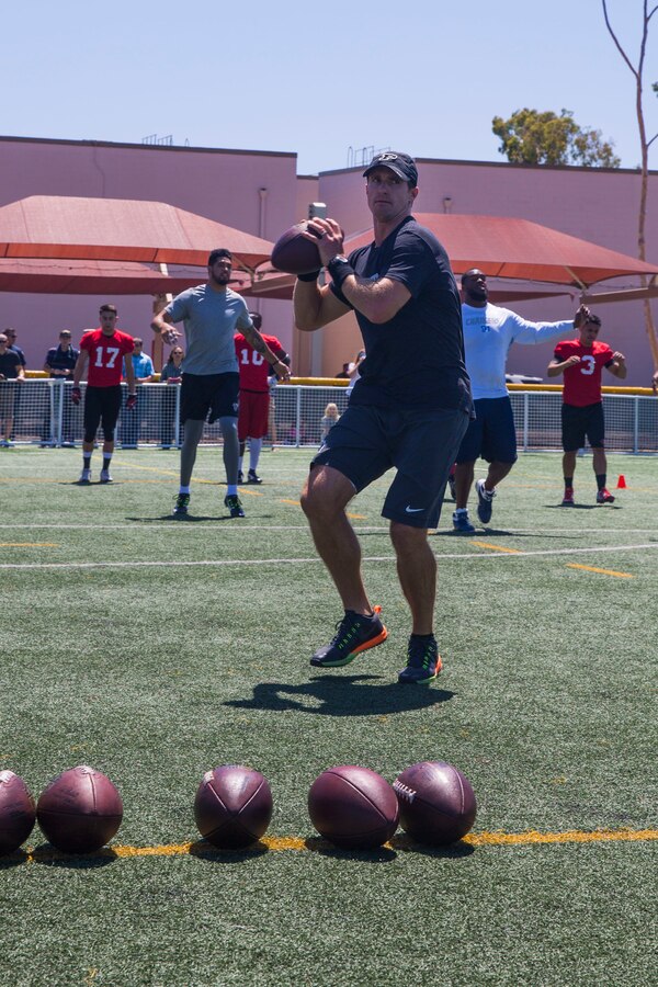 Drew Brees, starting quarterback for the New Orleans Saints, practices during the National Football League Star Experience at Marine Corps Air Station Miramar, California, July 14.  NFL players who train with Todd Durkin, a professional performance-enhancement coach and personal trainer, practiced with the Miramar Falcons football team and interacted with service members and families. (U.S. Marine Corps photo by Cpl. Alissa P. Schuning/Released)