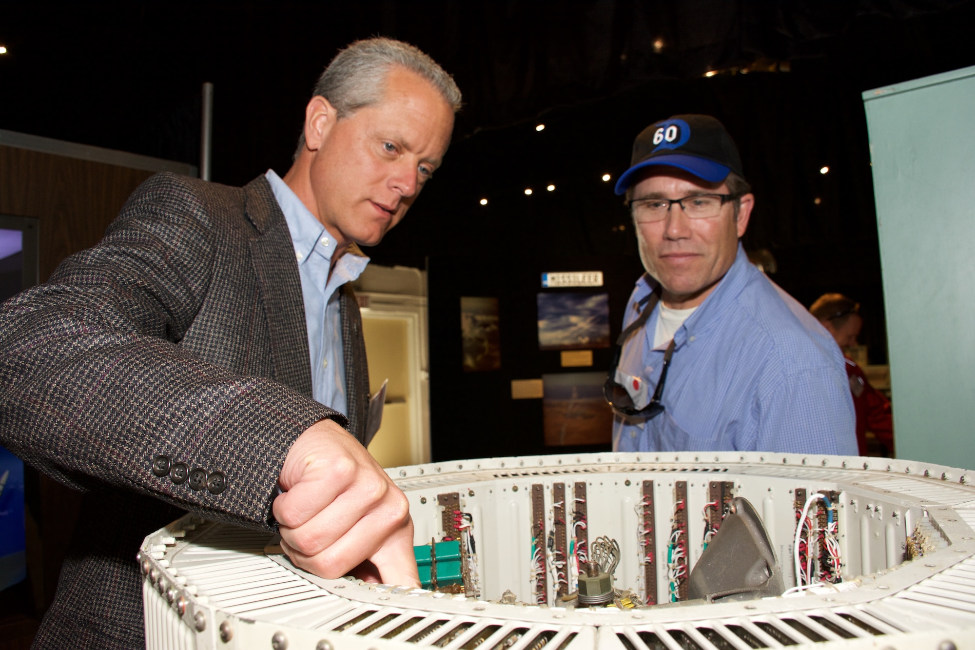 John Carli, 301st Airlift Squadron honorary commander and Vacaville Police Department police chief (left), and Monte Hoover, 15th Air Mobility Operations Squadron honorary commander and Gillespie's Abbey Carpet & Floor president and general manager, look at memorabilia at the 30th Space Wing Space and Missile Heritage Center during a fly-away civic leader tour to Vandenberg Air Force Base July 14, 2015. The purpose of fly-away civic leader tours is to give community leaders an opportunity to better understand the home unit and other Air Force installation’s missions and provide a greater insight into the Air Force's capabilities in air, space and cyberspace by exposing key community leaders to them. (U.S. Air Force photo/2nd Lt. Stephen J. Collier)