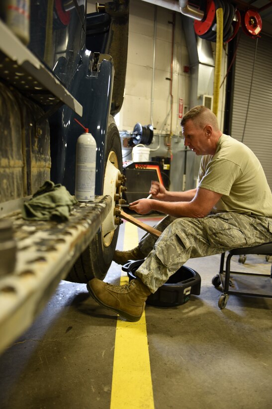 Staff Sgt. Justin Martz, heavy mobile equipment mechanic, 211th Engineering Installation Squadron, repairs the front end of a dump truck that is part of the 176th Wing, Joint Base Elmendorf-Richardson, Anchorage, Alaska, fleet. Martz is part of a three-person vehicle maintenance team who is working at JBER during the 211th's participation in Exercise Frosty Spear to assist the local VM shop during their summer rebuild. (U.S. Air National Guard photo by Staff Sgt. Claire Behney/Released)