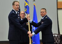 Maj. Ryan Murray, right, accepts command of the 341st Logistics Readiness Squadron from Lt. Col. Christoff Gaub, 341st Mission Support Group deputy commander, left, July 16, 2015, at the Grizzly Bend. Senior Master Sgt. Jesse Reisinger, 341st LRS superintendent, center, looks on. (U.S. Air Force photo/John Turner)