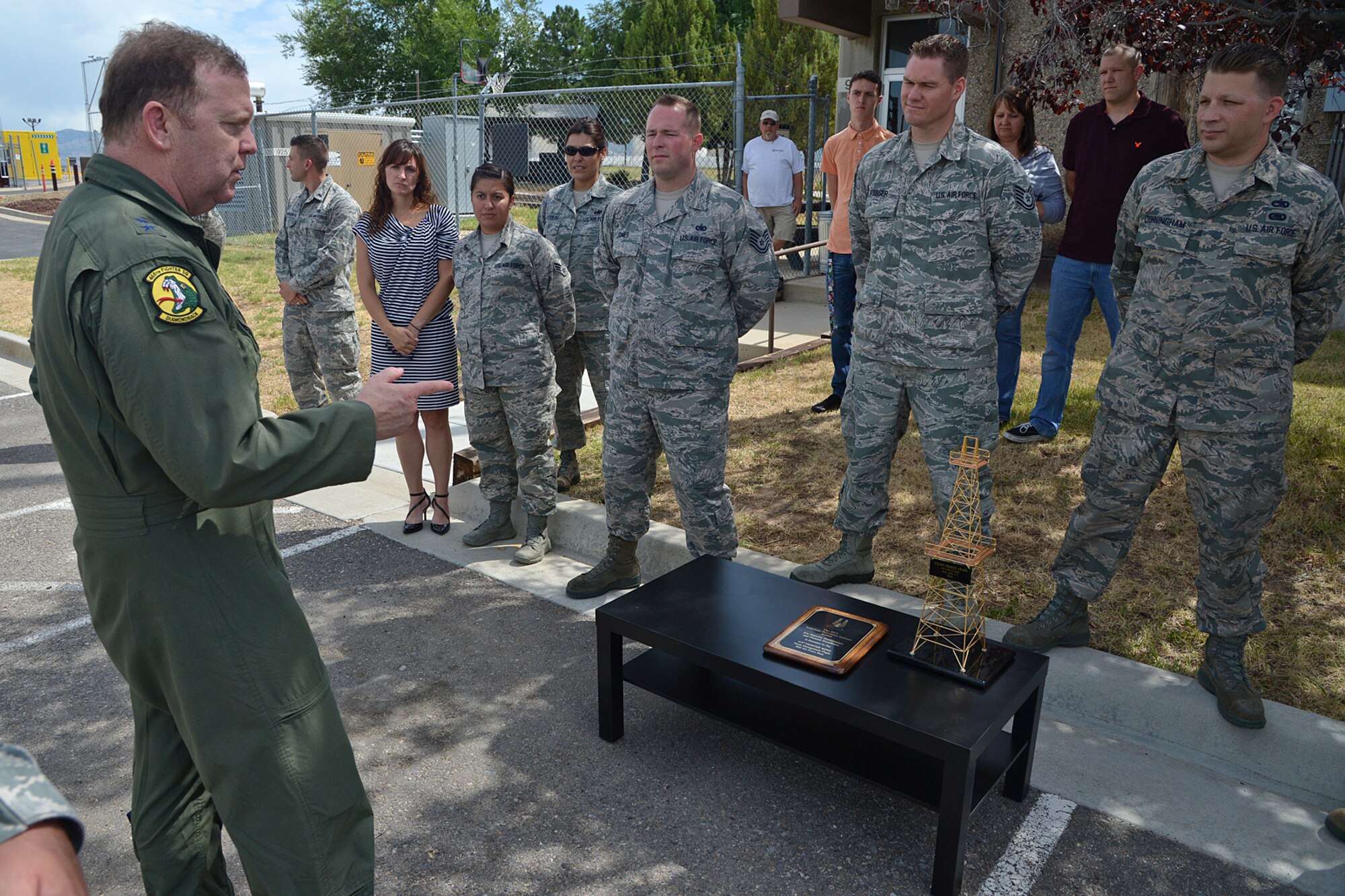 Maj. Gen. Richard Scobee, 10 Air Force commander, presents the “Golden Derrick Award” to the 419th Logistics Readiness Squadron fuels management flight during his visit here July 15. (U.S. Air Force photo/Alex Lloyd)