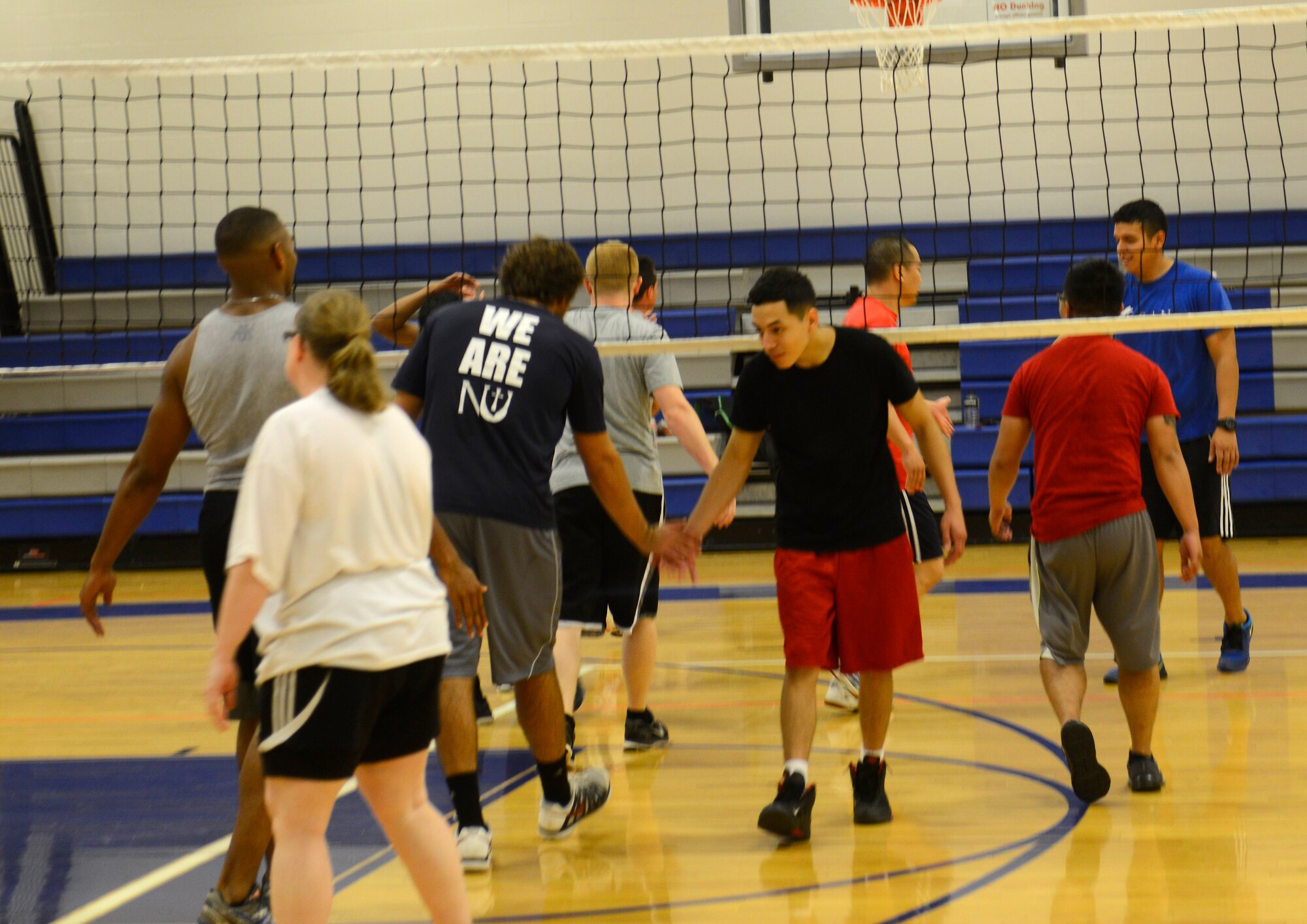 Airmen, dependents and their friends play volleyball at the McConnell Fitness Center, July 14, 2015, at McConnell Air Force Base, Kan. More than 30 people of various skillsets gathered in their off time to play against one another. Volleyball is one of many options McConnell members have at the base gym to work on their resiliency and fitness. (U.S. Air Force photo by Senior Airman Trevor Rhynes)