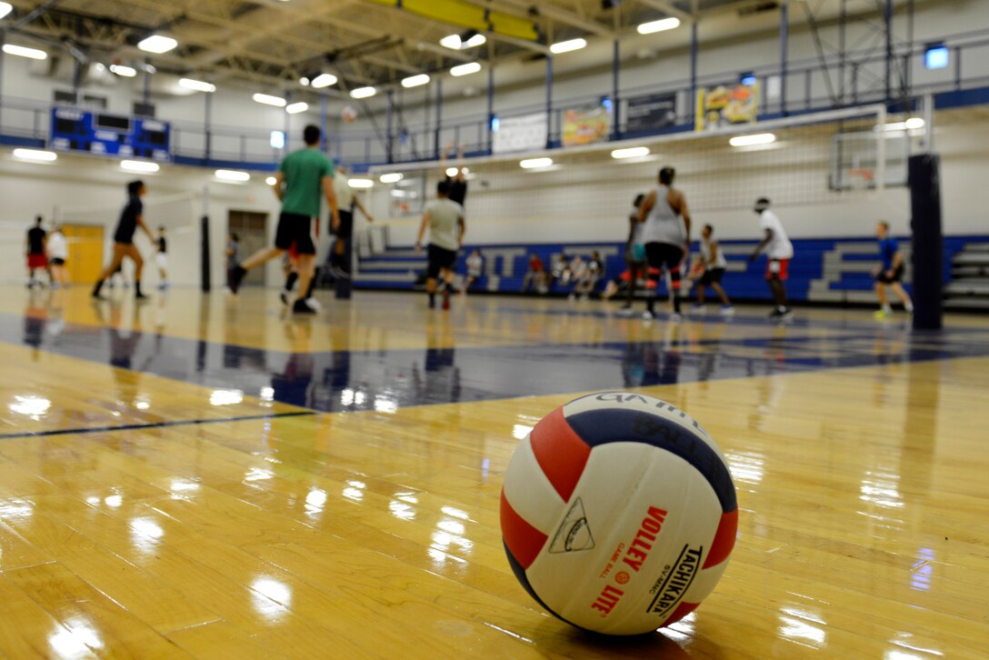 Airmen, dependents and their friends play volleyball at the McConnell Fitness Center, July 14, 2015, at McConnell Air Force Base, Kan. More than 30 people of various skillsets gathered in their off time to play against one another. Volleyball is one of many options McConnell members have at the base gym to work on their resiliency and fitness. (U.S. Air Force photo by Senior Airman Trevor Rhynes)