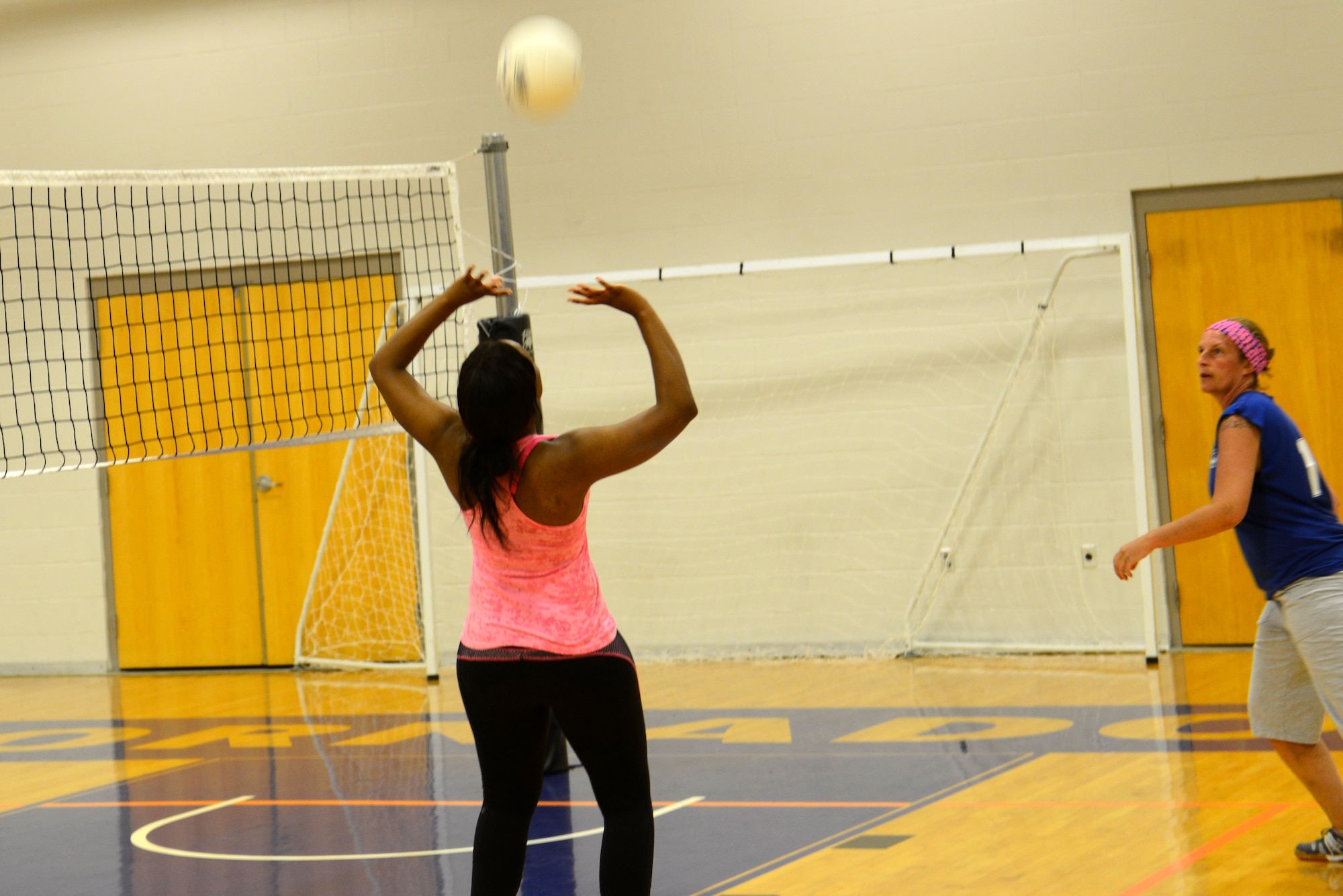 Airmen, dependents and their friends play volleyball at the McConnell Fitness Center, July 14, 2015, at McConnell Air Force Base, Kan. More than 30 people of various skillsets gathered in their off time to play against one another. Volleyball is one of many options McConnell members have at the base gym to work on their resiliency and fitness. (U.S. Air Force photo by Senior Airman Trevor Rhynes)