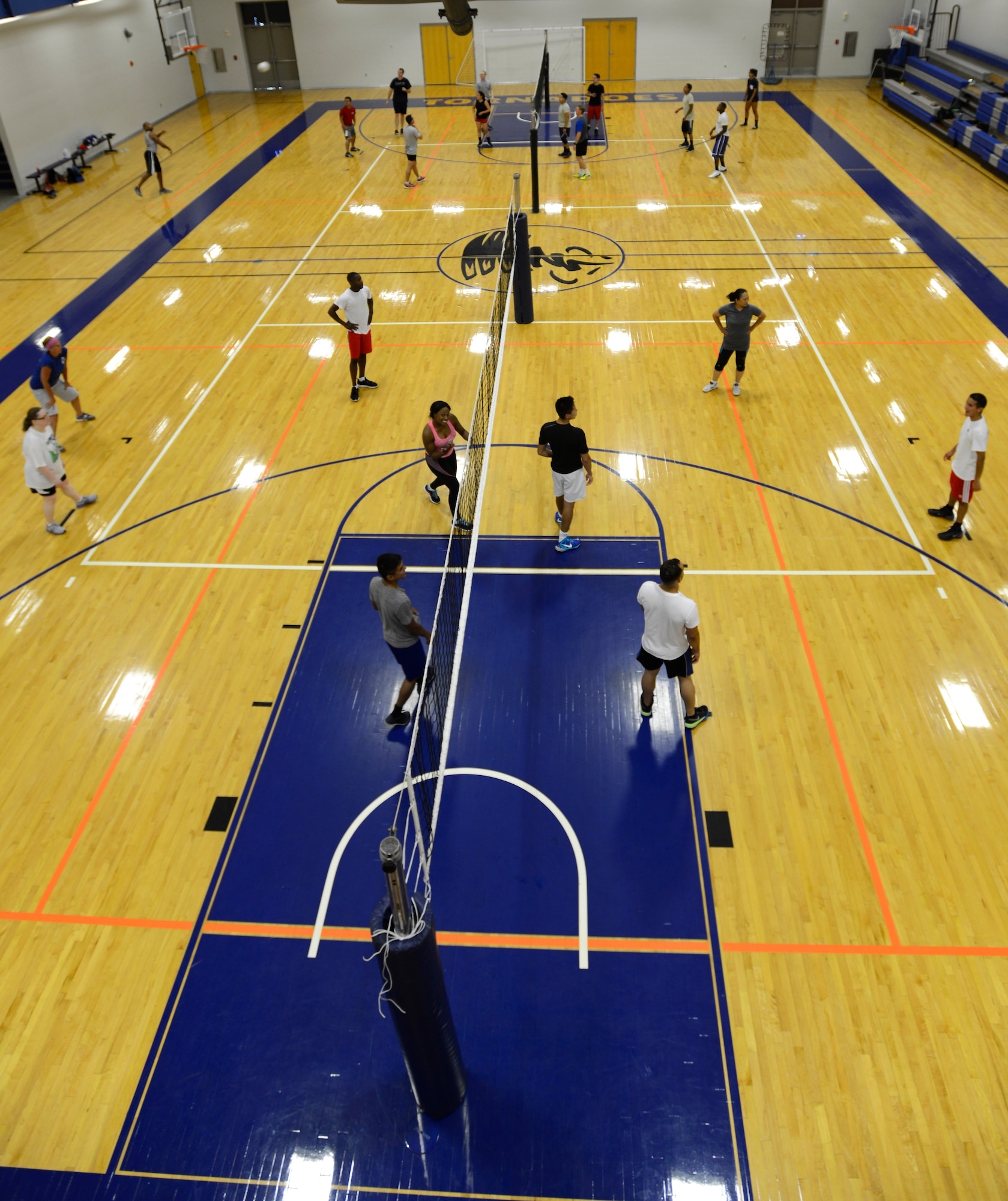 Airmen, dependents and their friends play volleyball at the McConnell Fitness Center, July 14, 2015, at McConnell Air Force Base, Kan. More than 30 people of various skillsets gathered in their off time to play against one another. Volleyball is one of many options McConnell members have at the base gym to work on their resiliency and fitness. (U.S. Air Force photo by Senior Airman Trevor Rhynes)