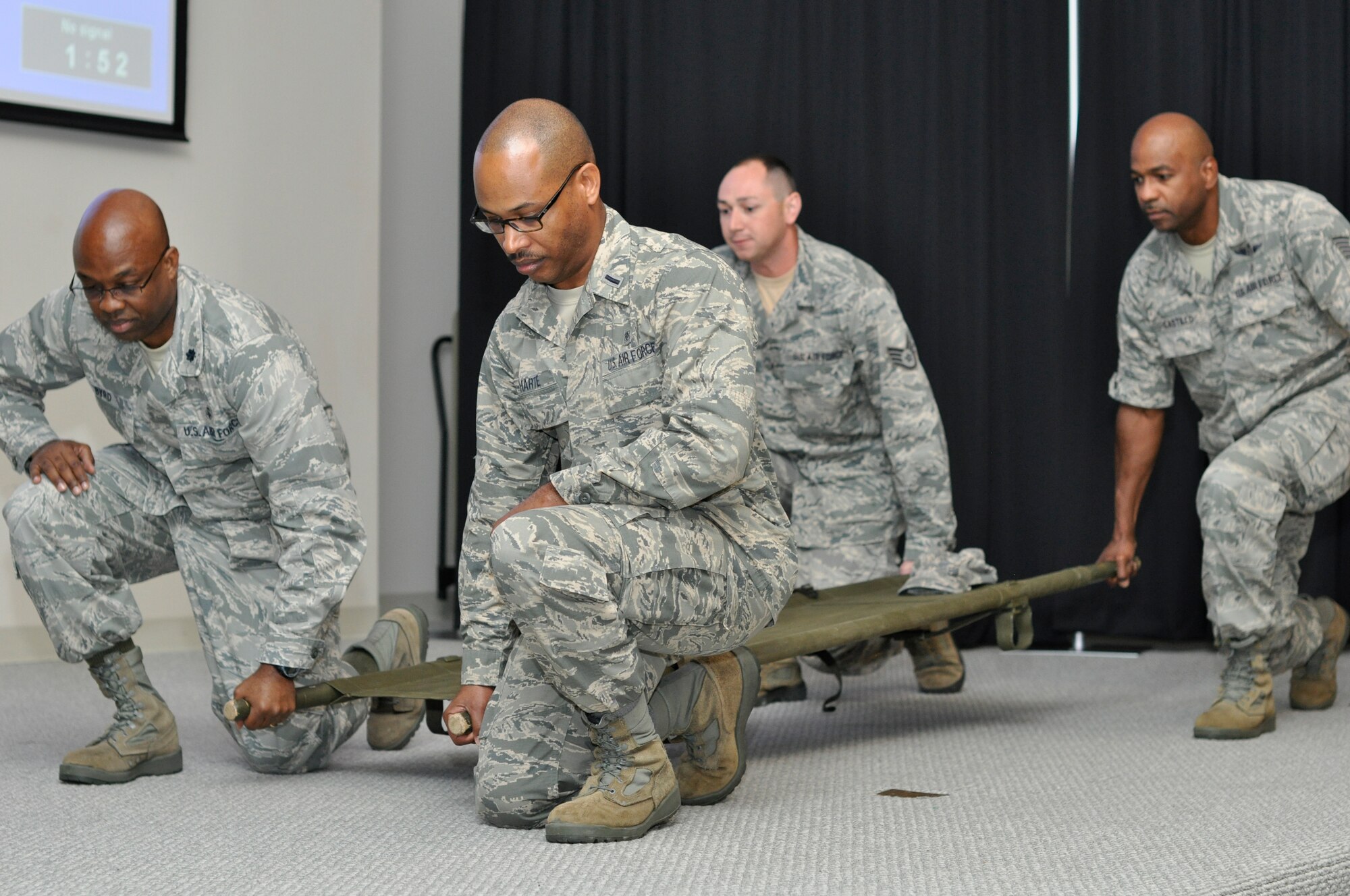 Members of the 514th Aerospace Medicine Squadron and 514th Aeromedical Staging Squadron, practice litter carry July 10, 2015, at Naval Air Station Key West, Fla. Members were demonstrating how to properly lift and carry a litter. (U.S. Air Force photo/Senior Airman Jasmine Zielomski)