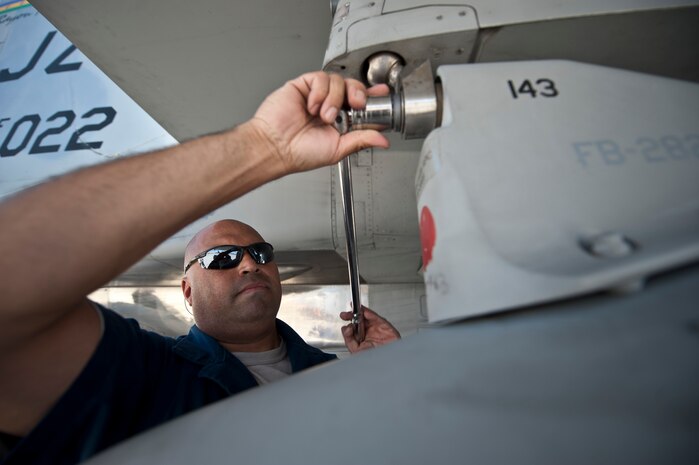 Tech. Sgt. Alexis Midence, 159th Maintenance Squadron crew chief, Louisiana Air National Guard, tightens a component on an F-15 Eagle during Red Flag 15-3 at Nellis Air Force Base, Nev., July 14, 2015. Crew chiefs are responsible for and dedicated to a single aircraft, and have their name stenciled on the aircraft along with the pilot’s. (U.S. Air Force photo by Staff Sgt. Siuta B. Ika)