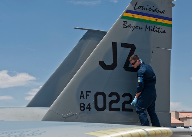 Airman 1st Class Cameron Harris, 159th Maintenance Squadron crew chief, Louisiana Air National Guard, inspects an F-15 Eagle for damage during Red Flag 15-3 at Nellis Air Force Base, Nev., July 14, 2015. Red Flag is a realistic combat training exercise involving the air, space and cyber forces of the U.S. and its allies, and is conducted on the vast bombing and gunnery ranges on the Nevada Test and Training Range. (U.S. Air Force photo by Airman 1st Class Jake Carter)