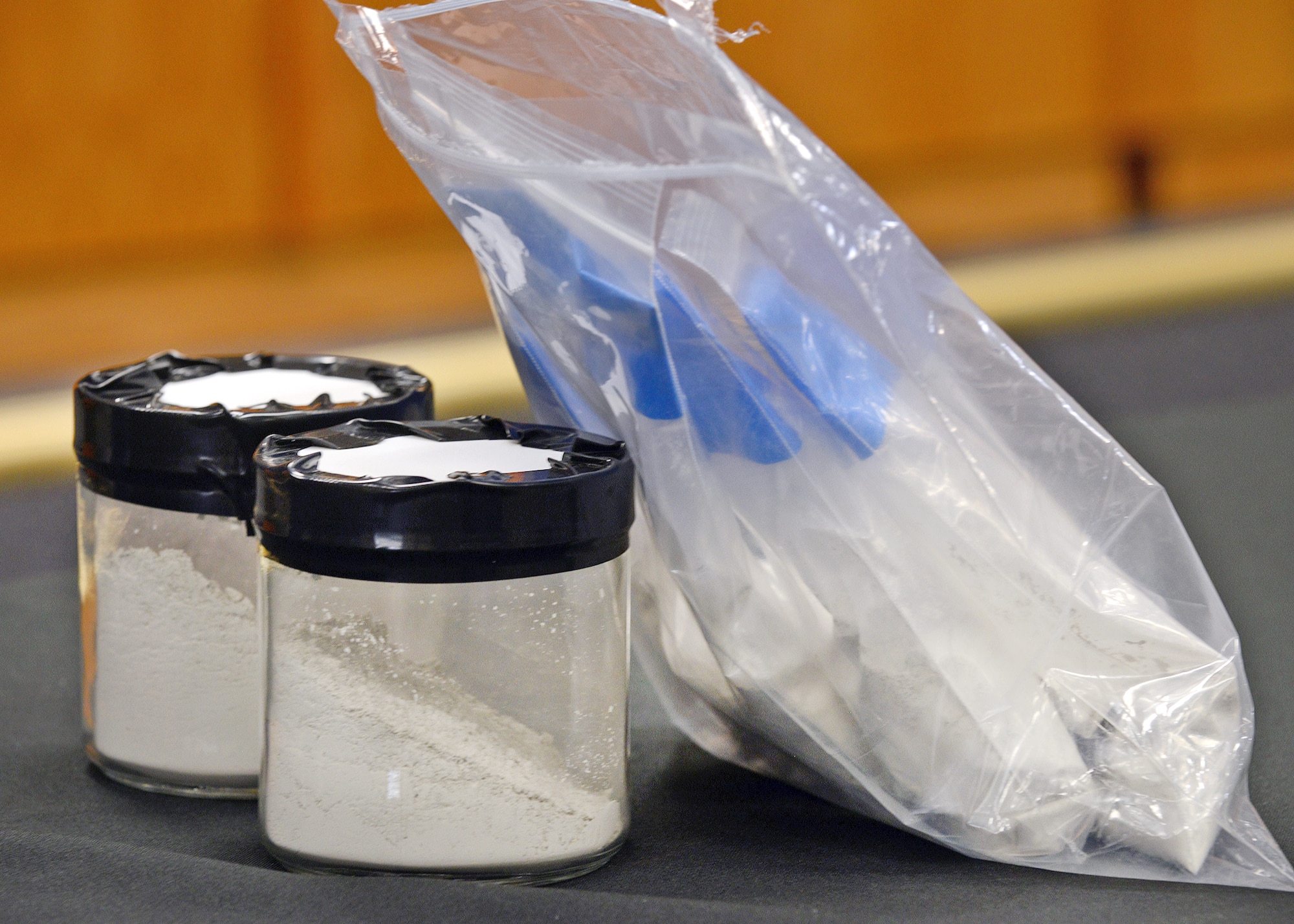The NASA Armstrong Flight Research Center displays volcanic ash that will be sprayed into a C-17 engine during the final phase of the Vehicle Integrated Propulsion Research (VIPR) project July 9. The team noted that they would be using Mazama ash, a compound that is made largely of glass which comes from Oregon, but is also native to California, to test and degrade the integrity of the engine. (U.S. Air Force photo by Jet Fabara)