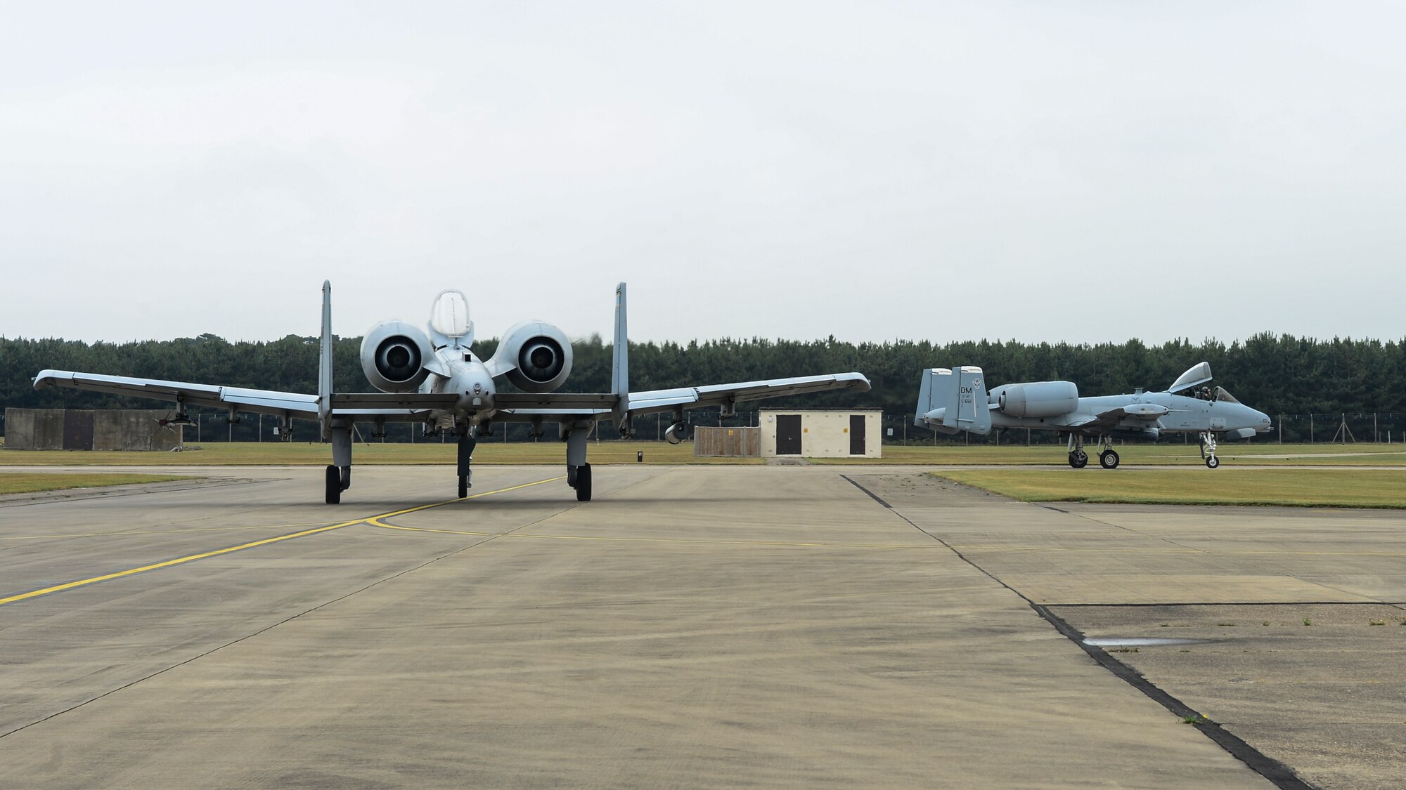 A Theater Security Package of two A-10C Thunderbolt II’s and Airmen from the 355th Fighter Wing, Davis-Monthan Air Force Base, Ariz. taxi down the runway at Royal Air Force Lakenheath, England, July 15, 2015. The A-10 was last stationed in England more than 20 years ago. (U.S. Air Force photo by Senior Airman Nigel Sandridge/Released)