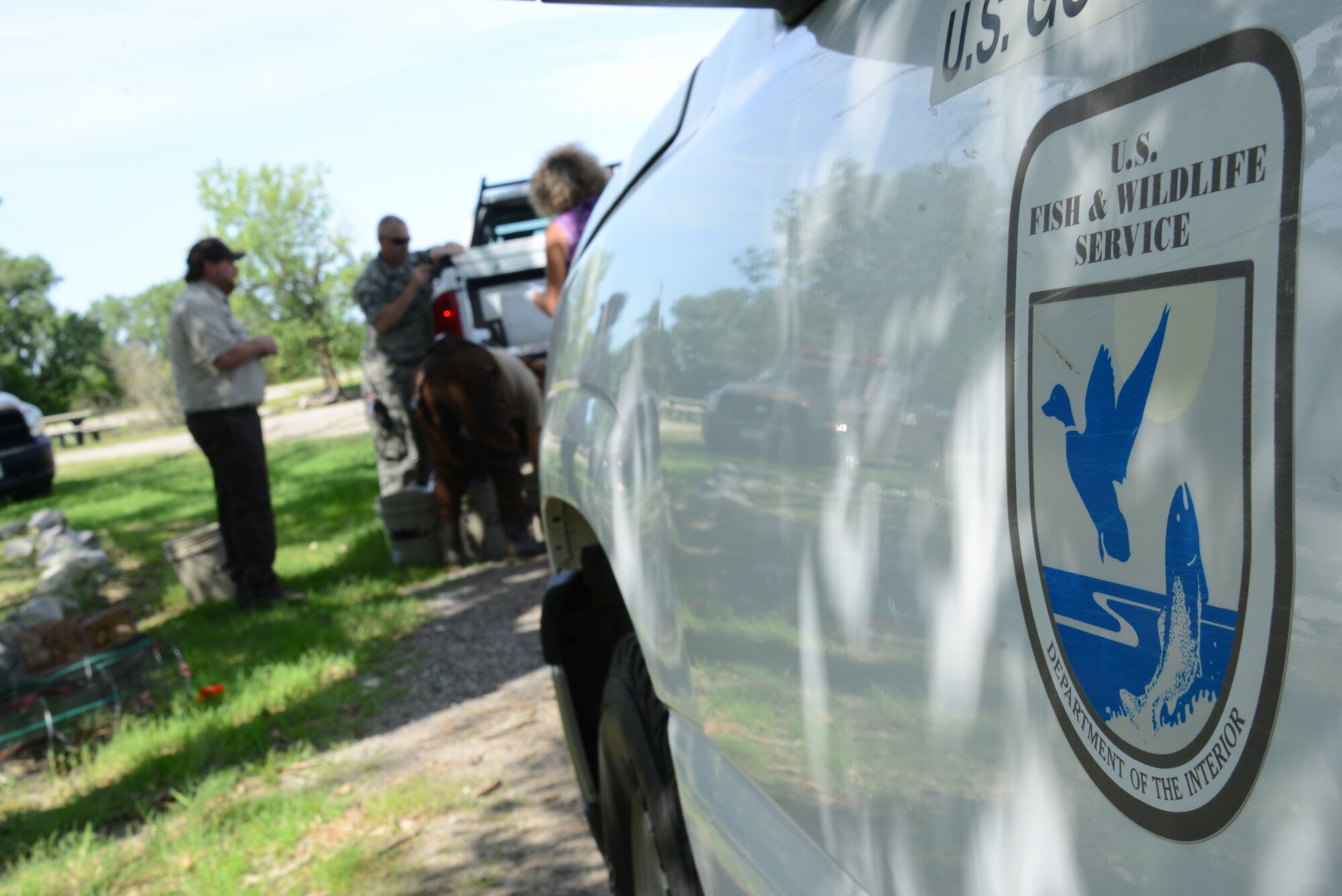 U.S. Fish and Wildlife Service biologists capture and inspect fish, July 15, 2015, at McConnell Air Force Base, Kan. The biologists inspect fish for lesions, age, size and species to make sure they are healthy and reproducing. (U.S. Air Force photo by Airman 1st Class Christopher Thornbury)