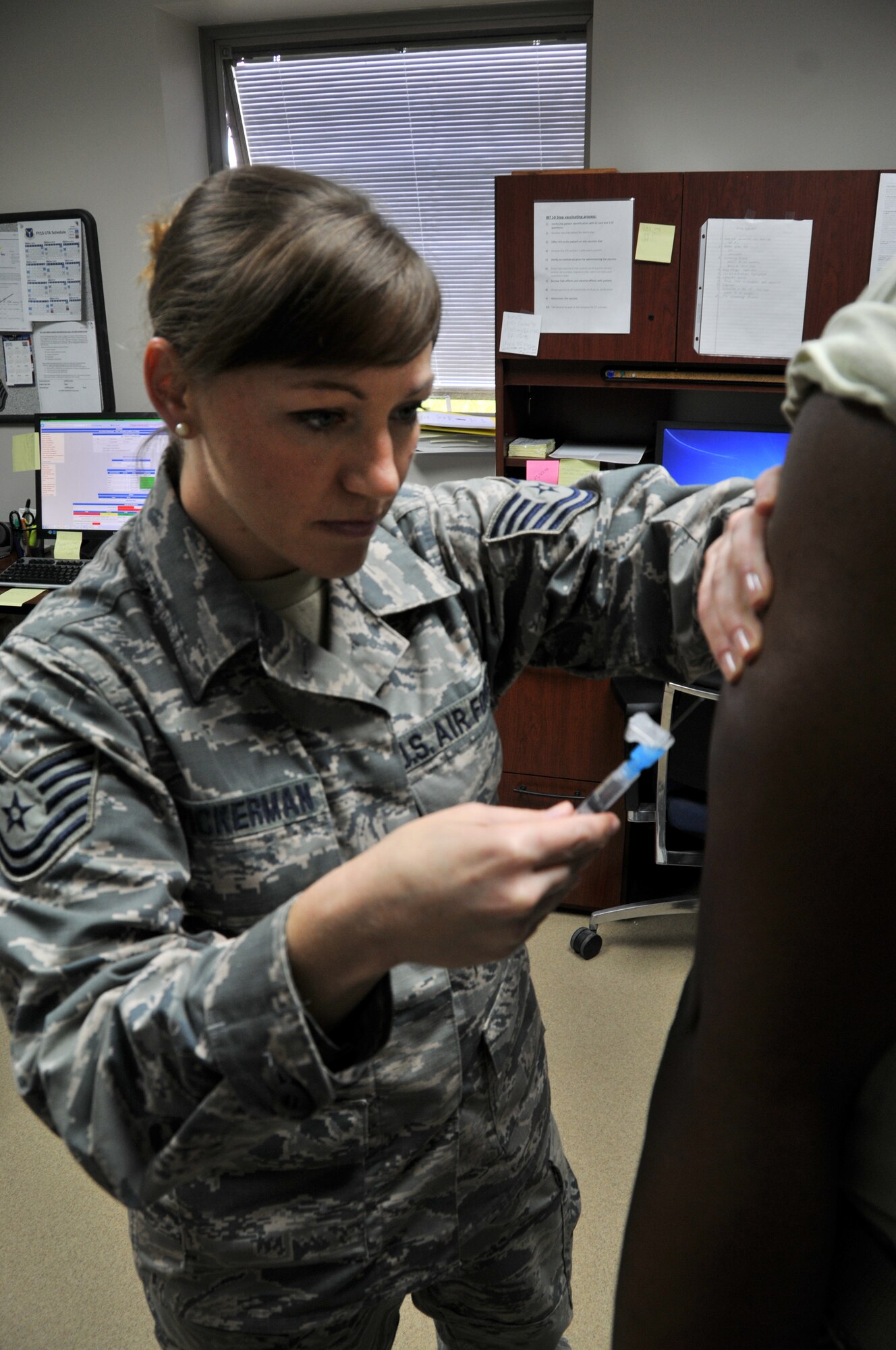 Tech. Sgt. Nicole P. Spickerman, 911th Aeromedical Staging Squadron, noncommissioned officer in charge of the immunization clinic, gives another member of the wing a shot in the arm July 12, 2015 at the Pittsburgh International Airport Air Reserve Station. The immunization clinic here is inundated with approximately 600 to 900 Airmen needing the flu shot every year. Spickerman recently graduated from University of Pittsburgh Medical Center at Mercy Hospital with a degree in nursing and she represents this month’s Airmen of the Burgh.