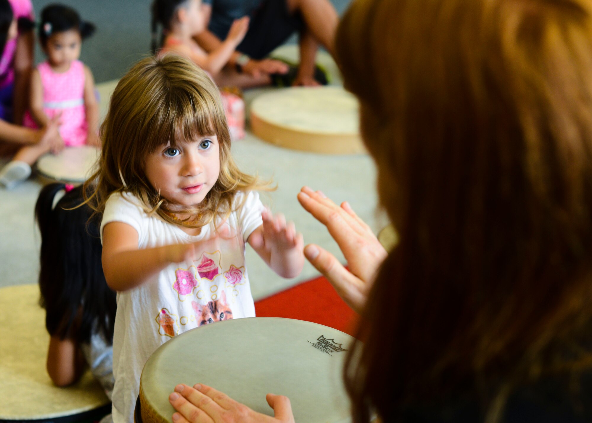 Paisley Linker, daughter of U.S. Air Force Staff Sgt. Justin Linker, plays the drums during JAM Summer Camp, July 14, 2015 at Aviano Air Base, Italy. The week-long event gave children a chance to release energy in a productive way. (U.S. Air Force photo by Senior Airman Austin Harvill/Released)