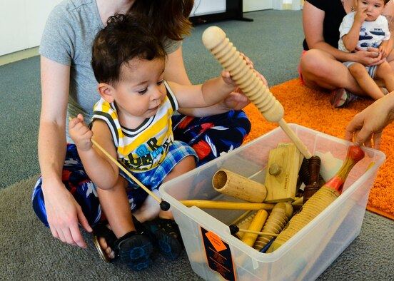 Rex Johnson, son of U.S. Air Force Staff Sgt. Steven Johnson, picks out a musical instrument during JAM Summer Camp, July 14, 2015, at Aviano Air Base, Italy. In addition to playing tunes, the children also shared, interacted and worked with other participants. (U.S. Air Force photo by Senior Airman Austin Harvill/Released) 