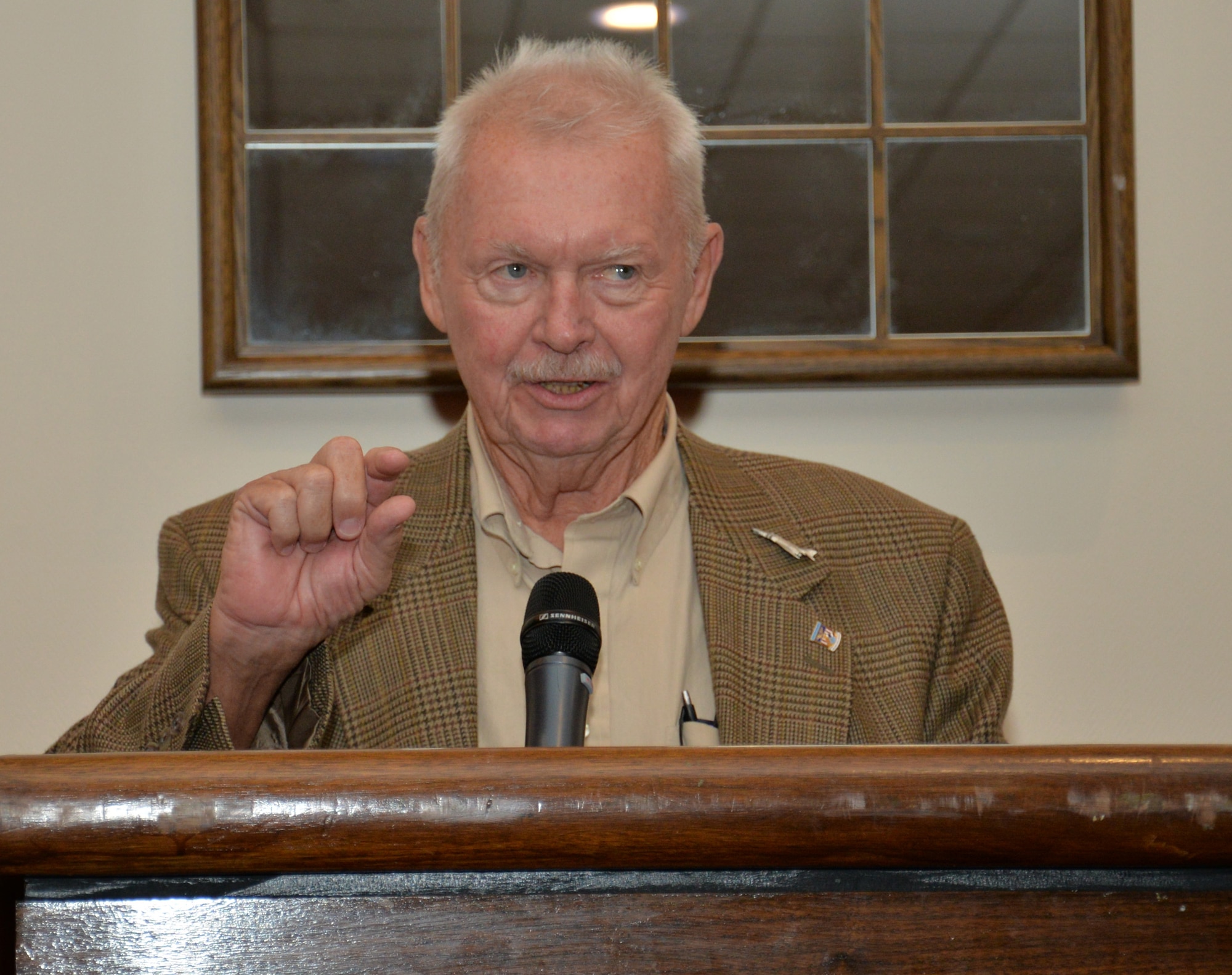 U.S. Air Force retired Maj. Spike Nasmyth, speaks with Team Mildenhall during a lunch July 8, 2015, in the Galaxy Club on RAF Mildenhall, England. Nasmyth spoke about how prisoners of war communicated with one another in the camp by tapping messages on the walls. He was a POW for more than six years. (U.S. Air Force photo by Gina Randall/Released)