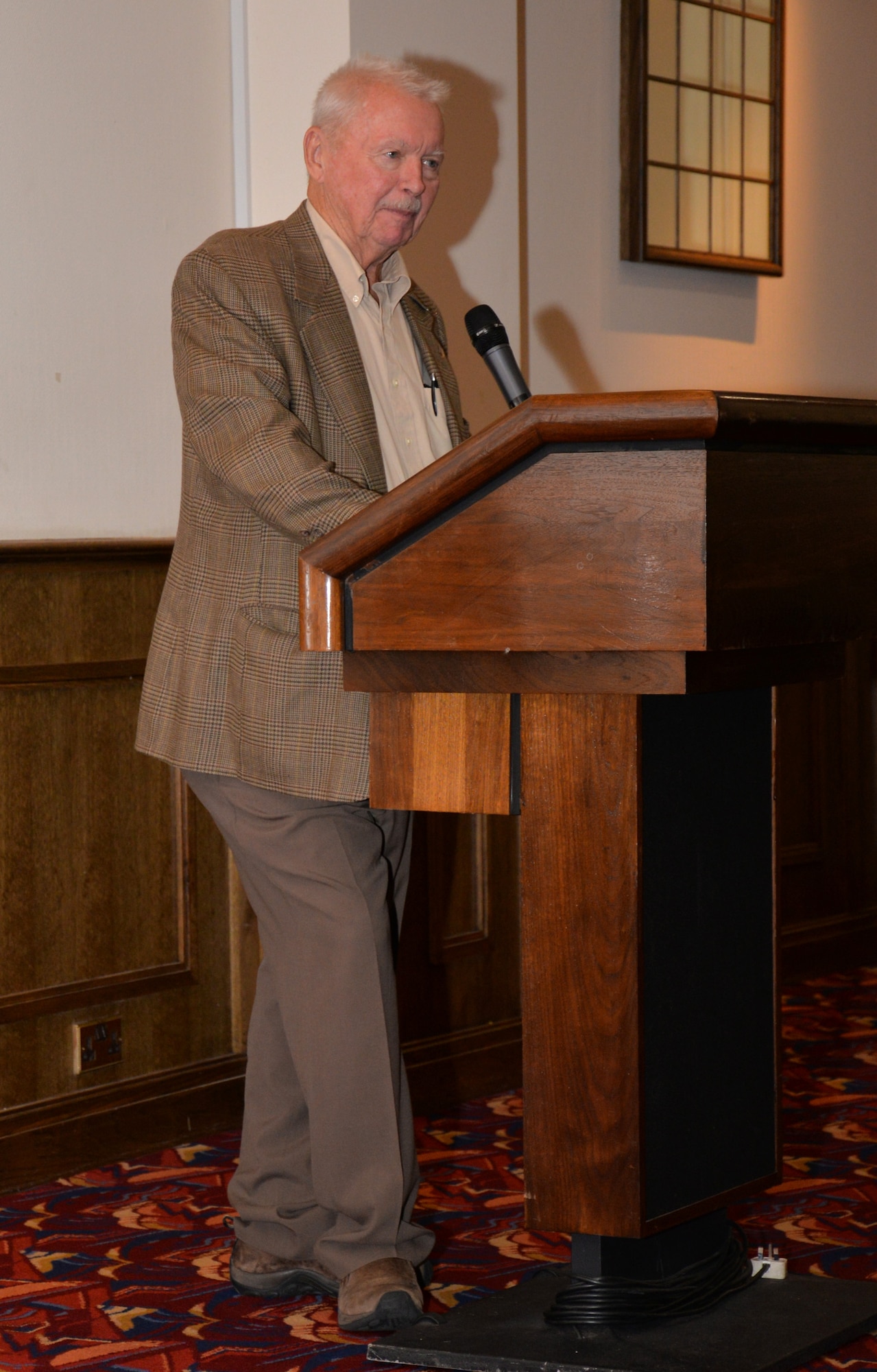 U.S. Air Force retired Maj. Spike Nasmyth, speaks with Team Mildenhall during a lunch July 8, 2015, in the Galaxy Club on RAF Mildenhall, England. Nasmyth spoke about his time as a prisoner of war in Vietnam and how he survived on a small amount of rice and soup for six-and-a-half years. He was a pilot who was shot down during a mission. (U.S. Air Force photo by Gina Randall/Released)