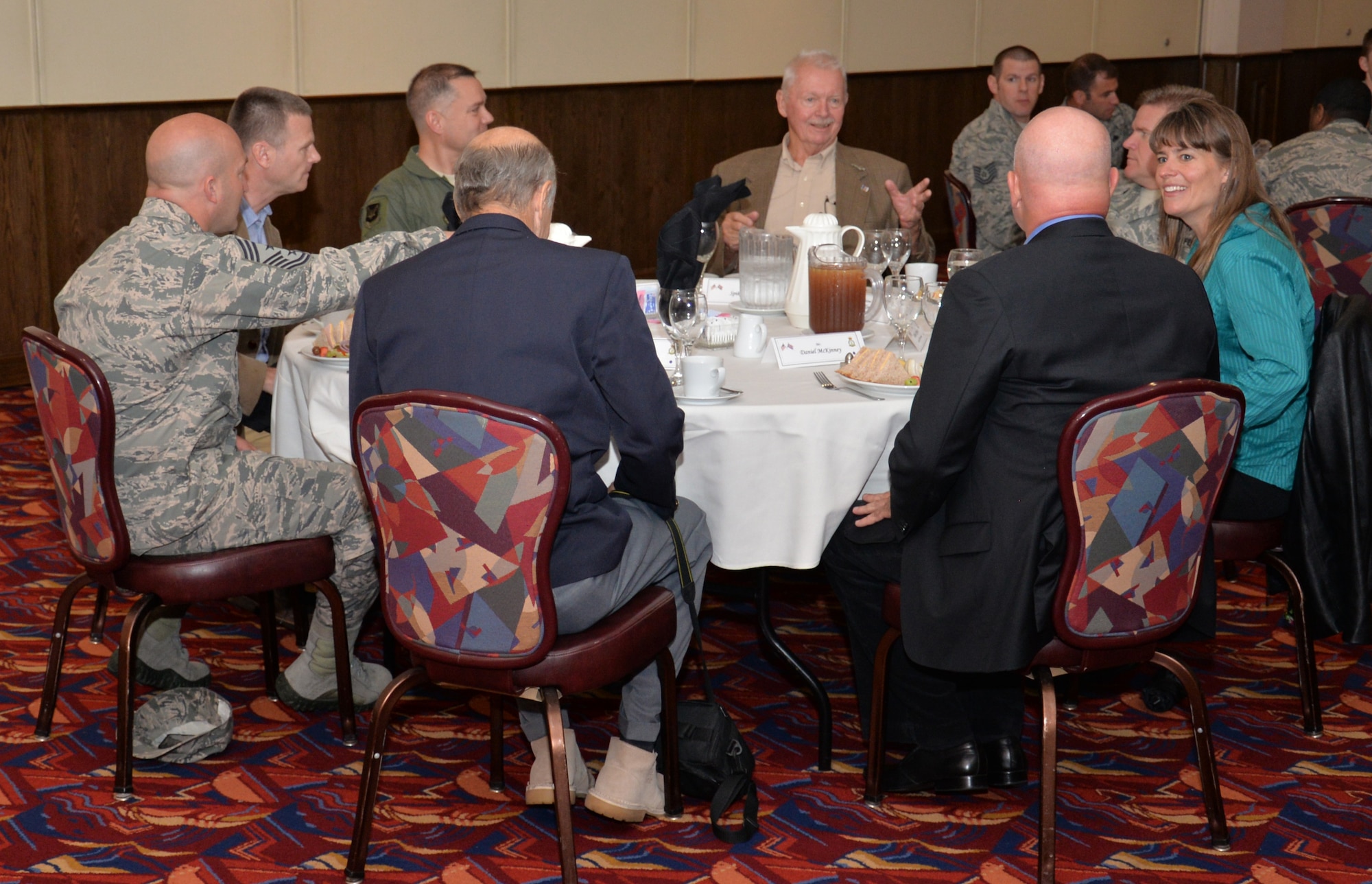 U.S. Air Force retired Maj. Spike Nasmyth, center, speaks with Team Mildenhall leadership during a lunch in his honor July 8, 2015, in the Galaxy Club on RAF Mildenhall, England. Nasmyth was a pilot during the Vietnam War and was shot down during a mission. (U.S. Air Force photo by Gina Randall/Released)